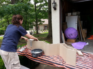 Staff member, Caroline, paper maching a snake.
